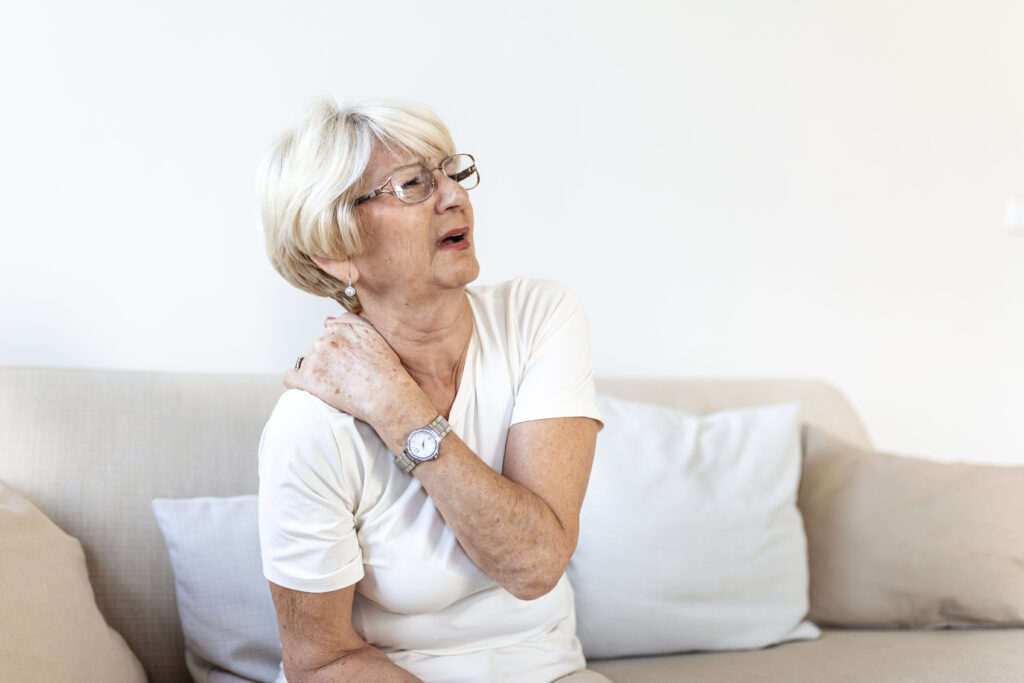close up of sad senior lady with neckache. senior woman with chronic pain syndrome fibromyalgia suffering from acute neckaches. senior woman suffering from neck pain